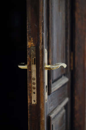 An Antique Open Door Inviting Exploration Wallpaper