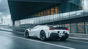 An Iconic Ferrari Spotted Driving Along The Street Wallpaper