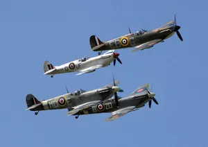 An Iconic Spitfire Aircraft In Flight Over England Wallpaper