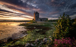 An Impressive Castle Overlooking The Coast Wallpaper