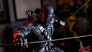 An Intricate Figurine Of Snake Eyes In Dynamic Pose Wallpaper