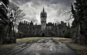 An Old Castle Stands Against An Overcast Sky. Wallpaper