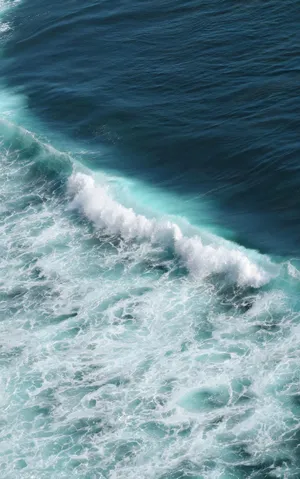 An Ombre Of Blues In A Tranquil Ocean Sunrise Wallpaper
