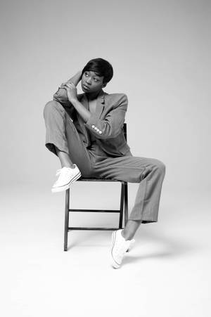 Androgynous Model On Chair Wallpaper