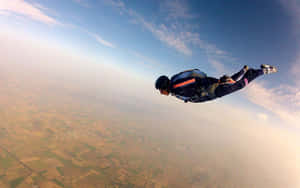 Angle Maneuver Over Cityscape Skydiving Wallpaper