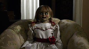 Annabelle Doll On Sofa Wallpaper