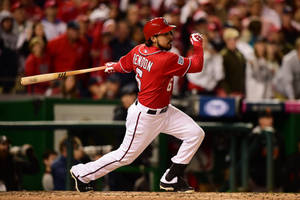 Anthony Rendon In Running Pose While Swinging Bat Wallpaper