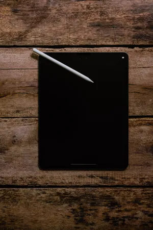 Apple Ipad Pro On Wood Wallpaper
