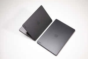 Apple Macbook In Stylish Black Color Wallpaper