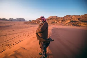 Arab Man Standing In Desert Wallpaper