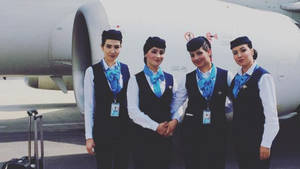 Ariana Afghan Airlines Flight Attendants On Duty Wallpaper