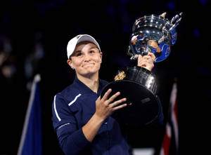 Ashleigh Barty Jubilantly Holding Her Trophy Wallpaper