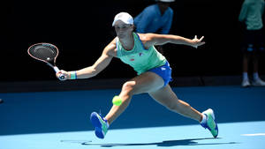 Ashleigh Barty Leaping For The Ball Wallpaper