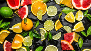 Assorted Citrus Fruitson Dark Background Wallpaper