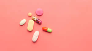 Assorted Medications Pink Background Wallpaper