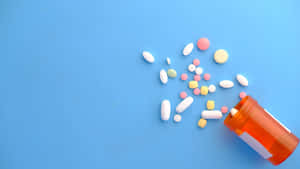 Assorted Medications Spilled From Bottle Wallpaper