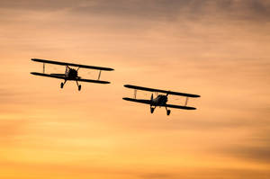 Aviation Black Silhouettes Of Two Biplanes Wallpaper