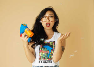 Awkwafina Holding A Bubble Gun Wallpaper