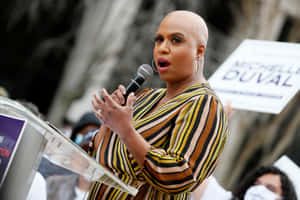 Ayanna Pressley Speaking At Podium Wallpaper
