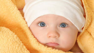 Baby Boy Wrapped In Yellow Towel Wallpaper