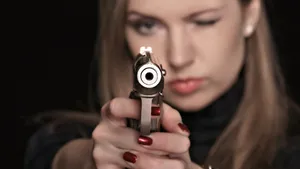 Bad Girl Pointing A Gun Wallpaper