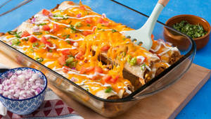 Baked Tray Of Cheesy Enchiladas With Onions Wallpaper