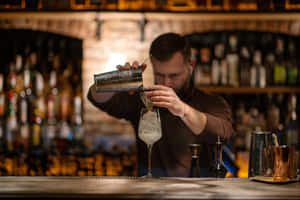 Bartender Pouring Cocktailat Bar.jpg Wallpaper