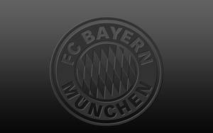 Bayern Munich's Iconic Logo On A Dark Gray Background Wallpaper