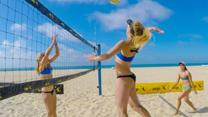 Beach Volleyball Game On White Sand Wallpaper