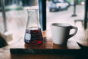 Beaker With Coffee And Mug Wallpaper