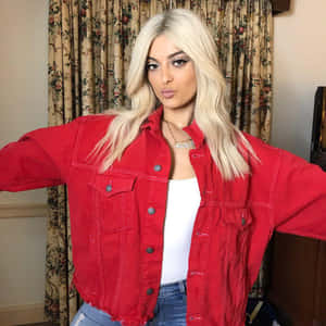 Bebe Rexha In A Striking Black Outfit On A Grand Stage, Owning The Limelight. Wallpaper