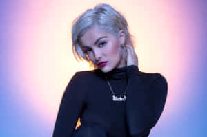 Bebe Rexha Striking A Pose On Stage Wallpaper