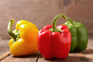 Bell Pepper Fruits On Wooden Platform Wallpaper