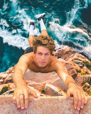 Ben Azelart Hanging On The Cliff Wallpaper