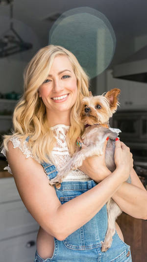 Beth Behrs With Puppy Wallpaper
