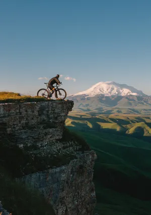 Bike Lover On A Cliff Wallpaper