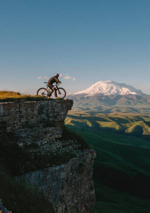 Bike Ride On Cliff Wallpaper
