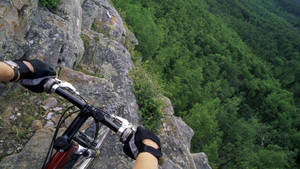 Bike Ride On Steep Cliff Wallpaper