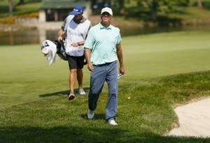 Bill Haas Striding Confidently Across The Golf Course Wallpaper