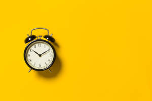 Black Alarm Clock Yellow Background Wallpaper