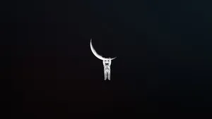 Black And White Astronaut Hang On Moon Wallpaper