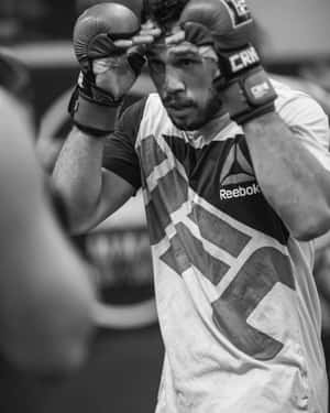 Black And White Brad Tavares With Boxing Gloves Wallpaper