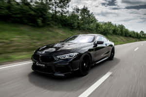 Black Bmw M8 On The Road 4k Wallpaper