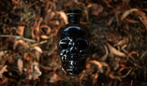 Black Crystal Head Vodka On Dried Leaves Wallpaper