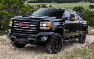 Black Duramax Climbing A Rocky Road Wallpaper