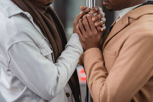 Black Gay Man Wearing A White Suit Wallpaper