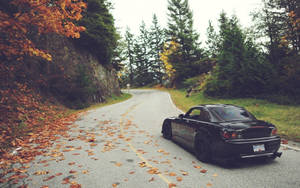 Black Jdm Car Cruising Down The Country Road Wallpaper