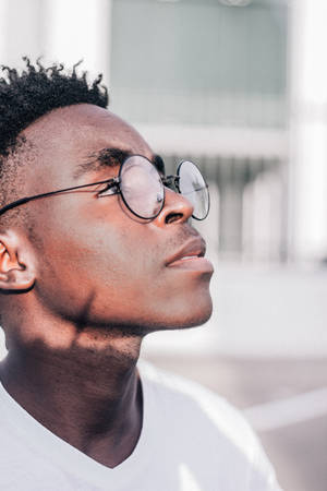 Black Man With Glasses On Out Under The Sun Wallpaper