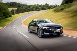 Black Polestar 2 Driving Through A Country Road Wallpaper