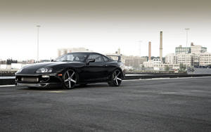 Black Toyota Supra Near City Bay Wallpaper